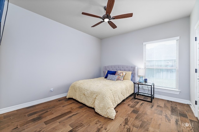 bedroom with dark wood-type flooring and ceiling fan