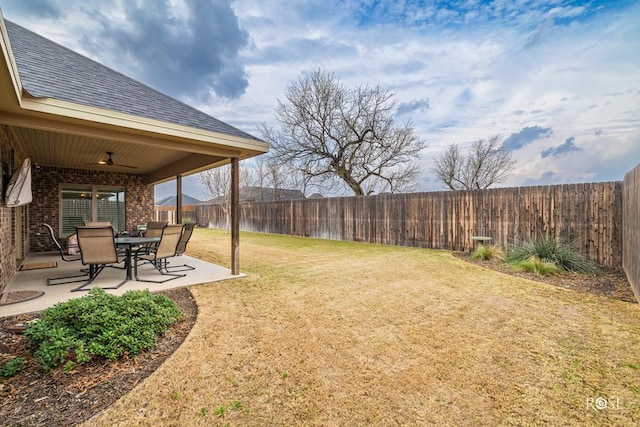 view of yard with ceiling fan and a patio