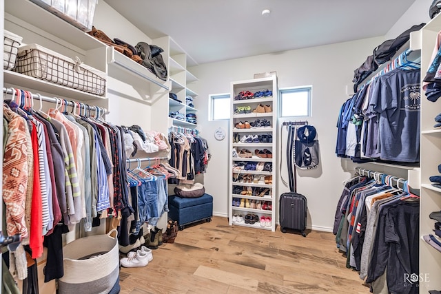 spacious closet with light hardwood / wood-style floors