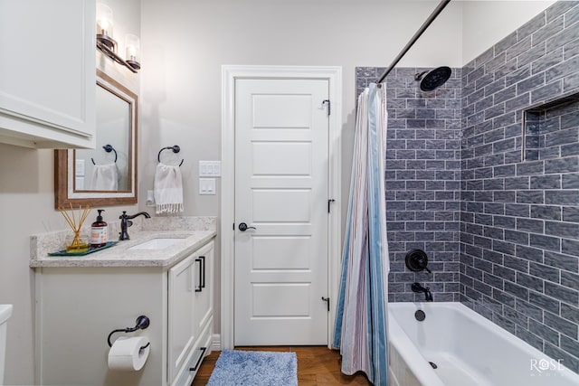 bathroom featuring vanity and shower / bath combination with curtain