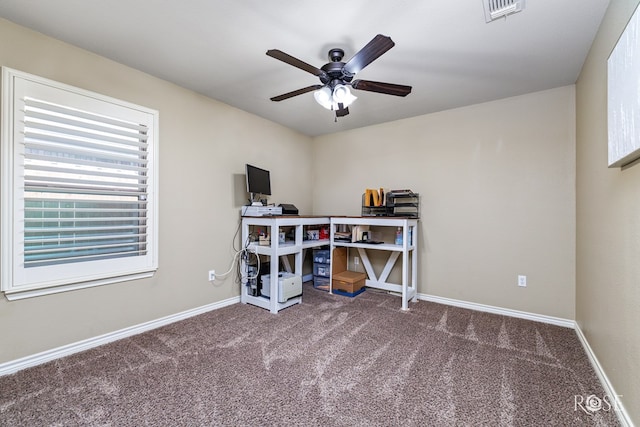 carpeted office with ceiling fan, visible vents, and baseboards