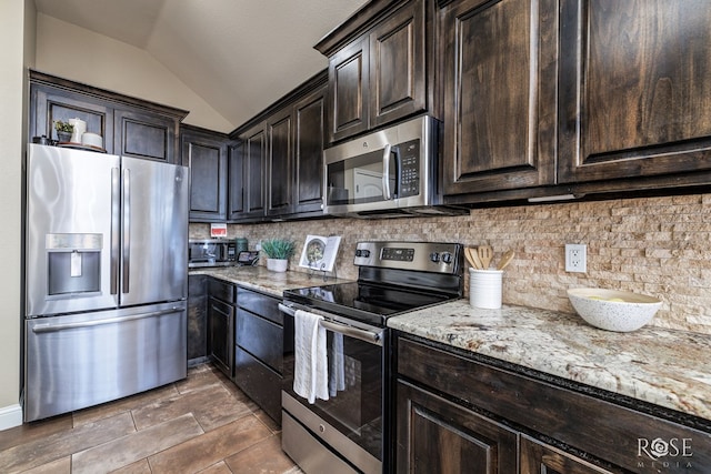 kitchen with tasteful backsplash, lofted ceiling, light stone countertops, stainless steel appliances, and dark brown cabinets