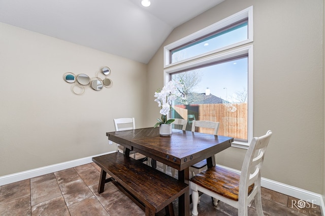 dining area with vaulted ceiling and baseboards