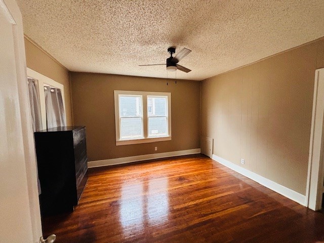 interior space featuring a textured ceiling, hardwood / wood-style floors, and ceiling fan