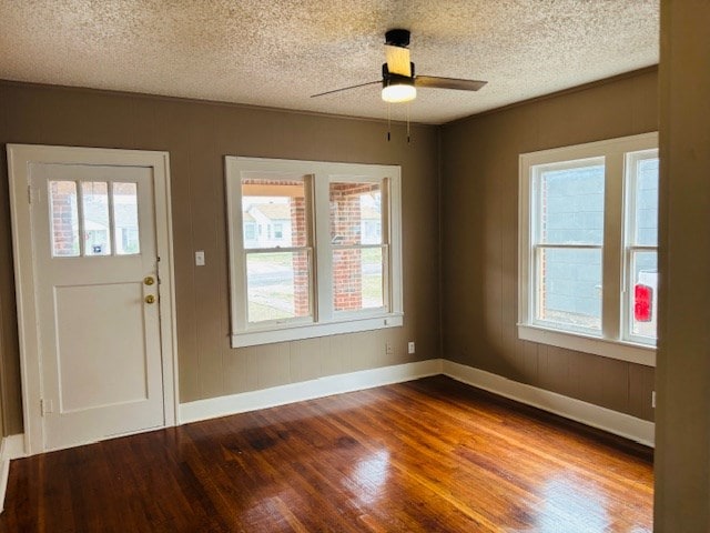 foyer with hardwood / wood-style flooring, ceiling fan, and a textured ceiling