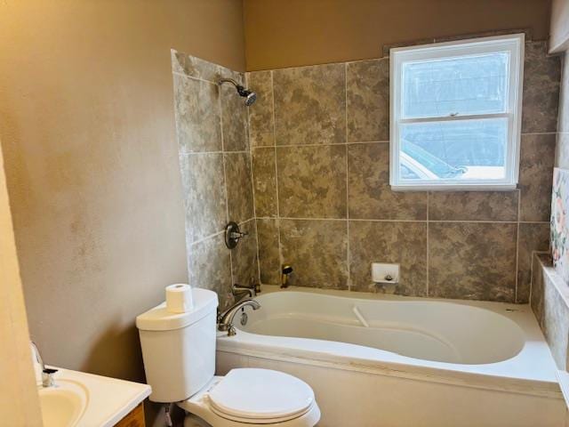 full bathroom with toilet, vanity, and tiled shower / bath combo