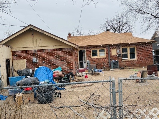 rear view of property featuring cooling unit