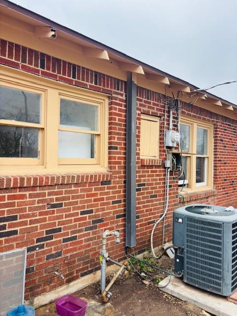 view of side of property featuring central AC unit