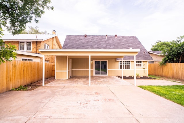 rear view of house featuring a sunroom