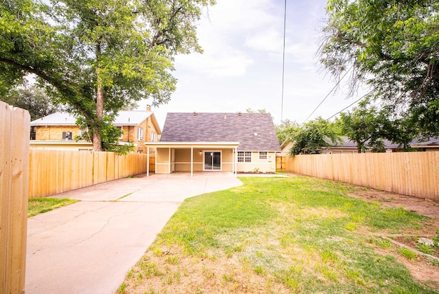 back of property featuring a yard and a patio area