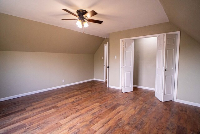 additional living space featuring ceiling fan, lofted ceiling, and dark hardwood / wood-style flooring