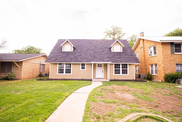 view of front of property featuring cooling unit and a front lawn