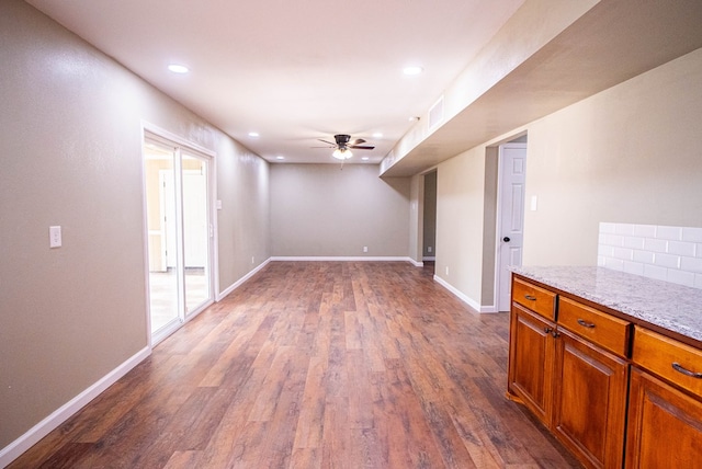 interior space featuring ceiling fan and dark hardwood / wood-style flooring