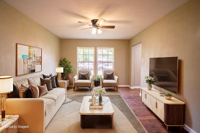 living room featuring hardwood / wood-style floors and ceiling fan