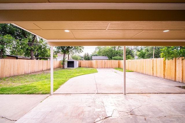 view of patio featuring a storage unit