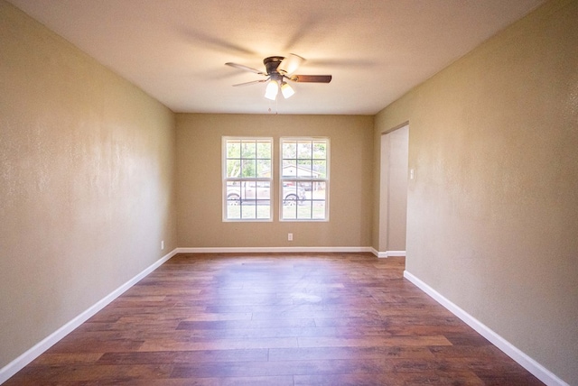 unfurnished room with dark hardwood / wood-style floors and ceiling fan