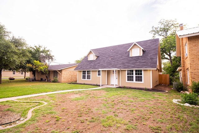 cape cod house featuring a front yard