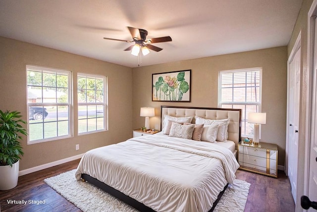 bedroom with dark hardwood / wood-style flooring, a closet, and ceiling fan