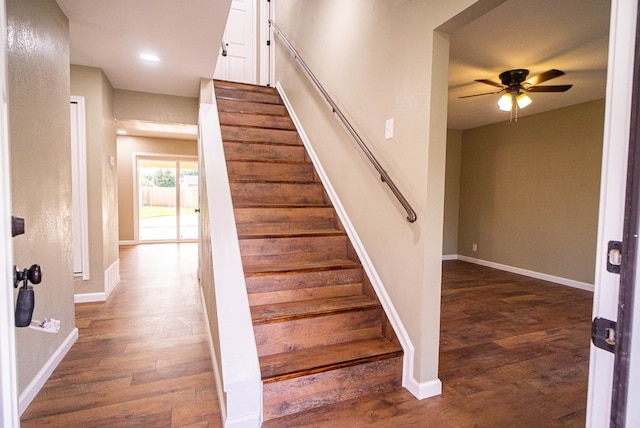 staircase with ceiling fan and hardwood / wood-style floors