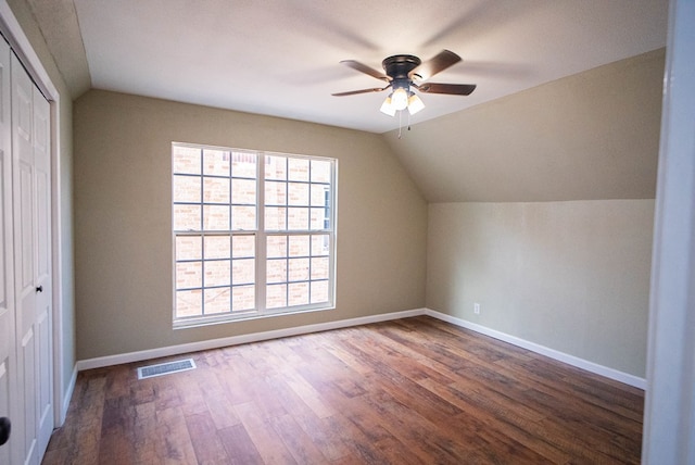 bonus room with lofted ceiling, dark hardwood / wood-style floors, and ceiling fan