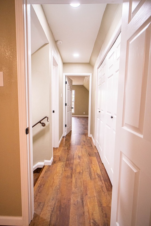 corridor with hardwood / wood-style flooring