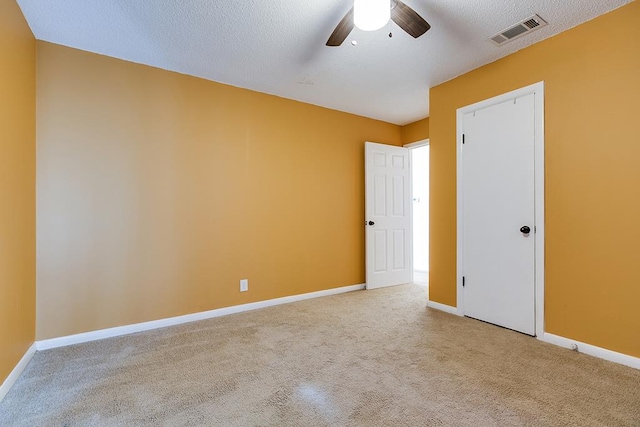 spare room featuring a textured ceiling and ceiling fan