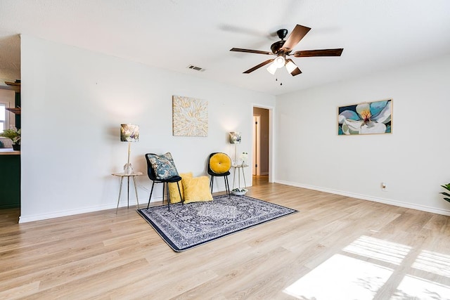 sitting room with light hardwood / wood-style flooring and ceiling fan