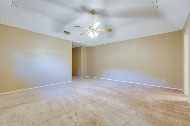 empty room with ceiling fan, light colored carpet, and a textured ceiling