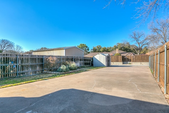 view of front of home with a patio and a storage shed