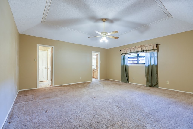 carpeted spare room with ceiling fan, a tray ceiling, and a textured ceiling