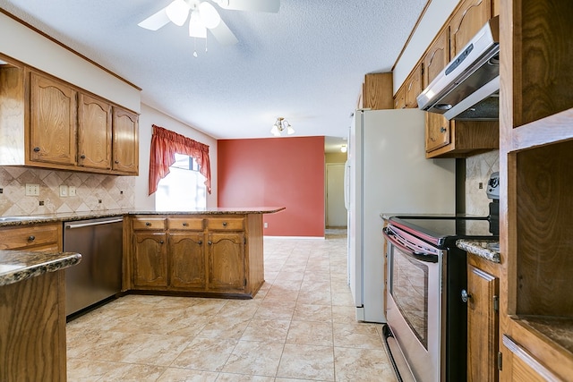 kitchen with stainless steel appliances, ventilation hood, decorative backsplash, and a textured ceiling