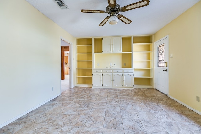 interior space with built in shelves and ceiling fan