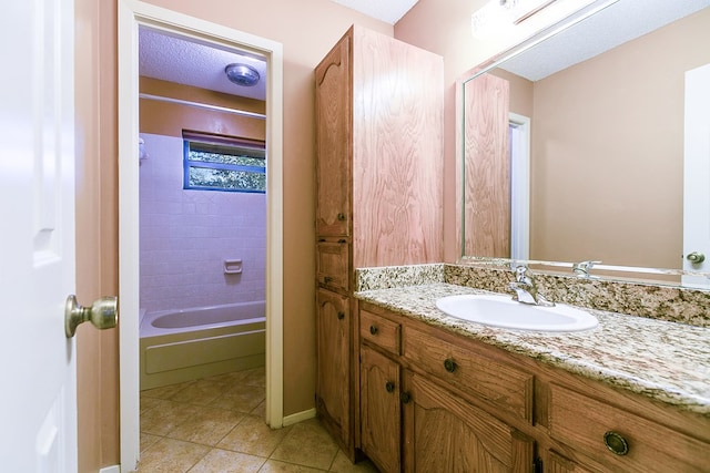 bathroom featuring vanity, tub / shower combination, tile patterned flooring, and a textured ceiling