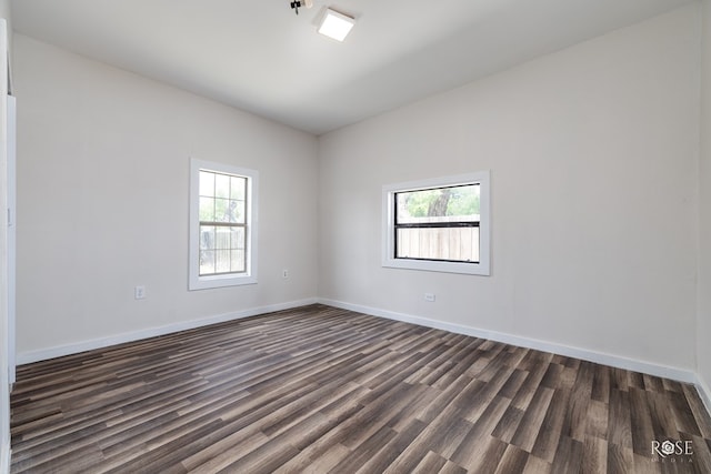 415 E Harris Ave, San Angelo, TX 79903 - spare room with dark wood-style flooring and baseboards