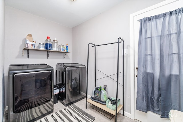 clothes washing area with washer and clothes dryer