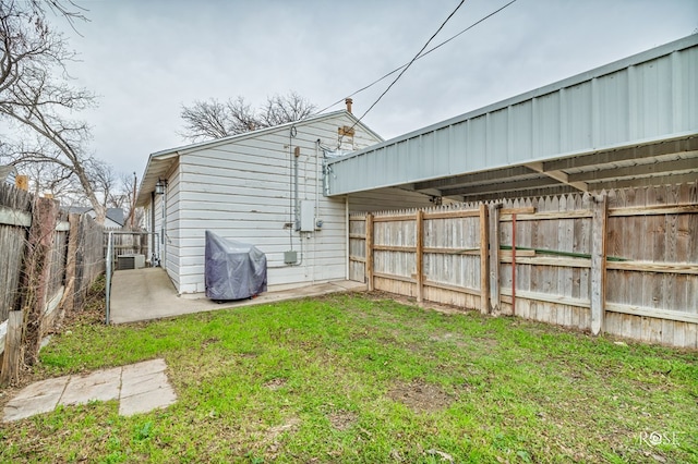 rear view of house featuring central AC, a patio area, and a lawn