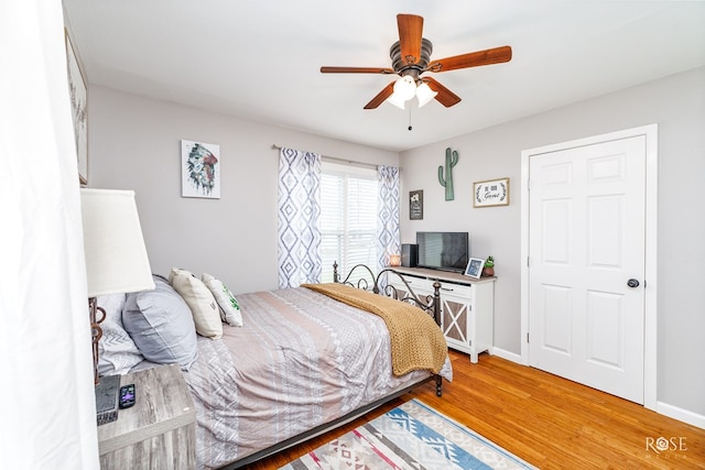 bedroom with wood-type flooring and ceiling fan