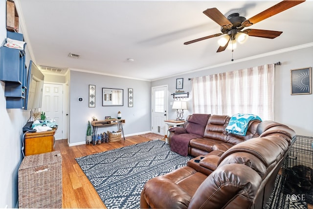 living room with crown molding, hardwood / wood-style floors, and ceiling fan