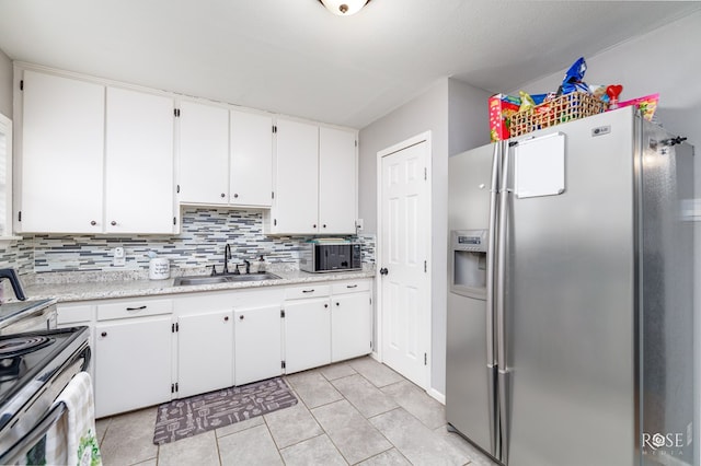 kitchen featuring stainless steel appliances, sink, and white cabinets