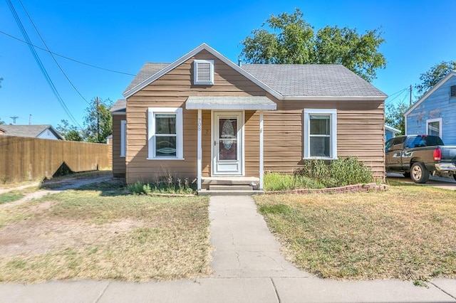 bungalow-style house featuring a front yard