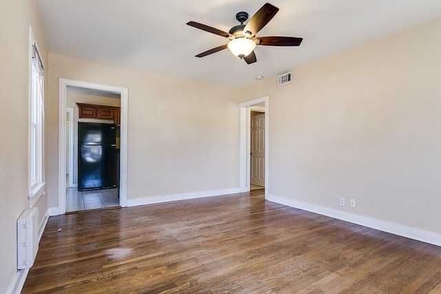 unfurnished room with ceiling fan and dark hardwood / wood-style floors