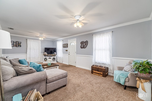 1951 W Twohig Ave, San Angelo, TX 76901 - carpeted living room featuring a ceiling fan, crown molding, and wainscoting