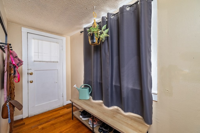 mudroom featuring hardwood / wood-style flooring and a textured ceiling