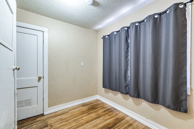 interior space with hardwood / wood-style floors and a textured ceiling