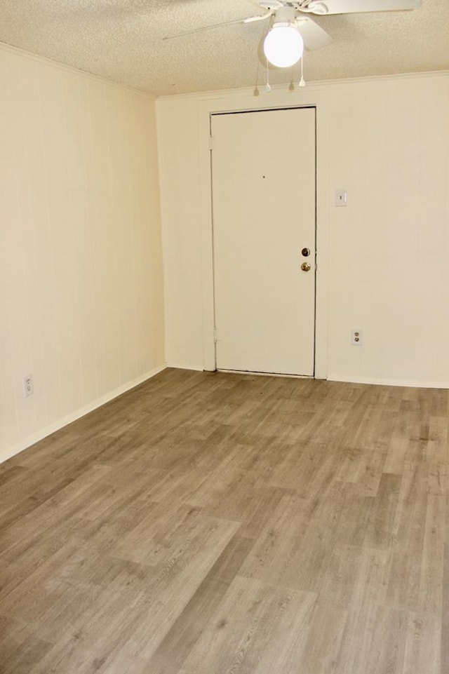 spare room featuring hardwood / wood-style floors and a textured ceiling