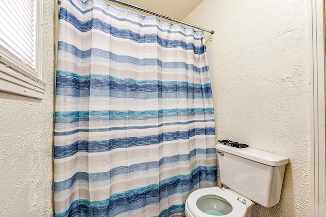 bathroom with toilet and walk in shower