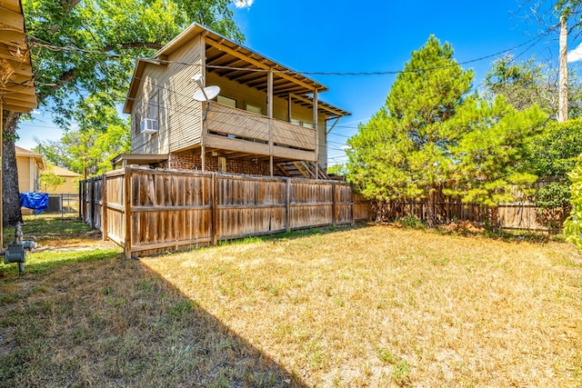 back of property with cooling unit and a yard