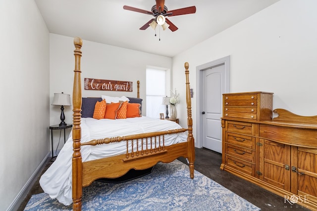 bedroom with ceiling fan, dark colored carpet, and baseboards