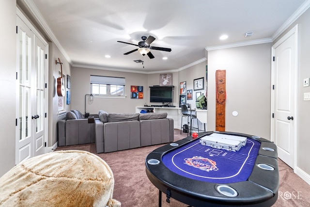 rec room featuring carpet, a ceiling fan, and crown molding