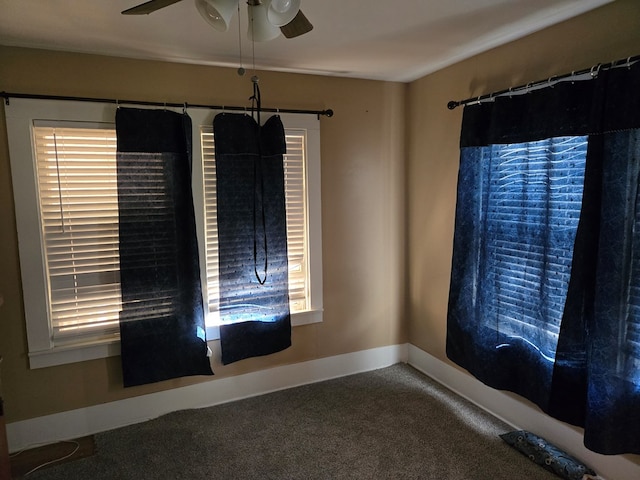 carpeted spare room featuring ceiling fan